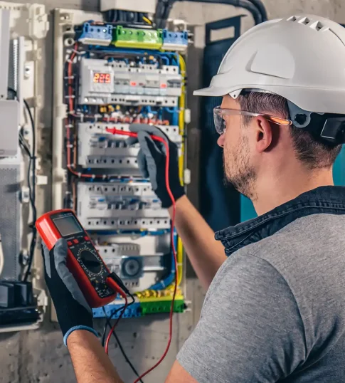 man-electrical-technician-working-switchboard-with-fuses-1